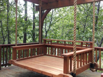 Wooden bed on patio hanging with Manila rope