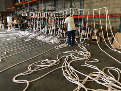 In the warehouse man making custom ropes
