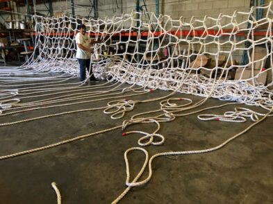 In the warehouse man making custom ropes