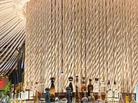Custom ropes design behind a bar with bartender in front serving