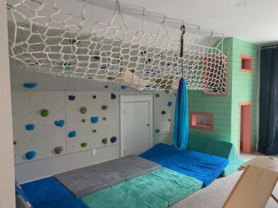 White net hanging from the ceiling in a child's gym