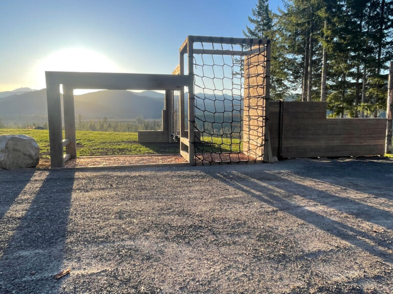Outside gym made out of wood with ropes and cargo net to climb on.